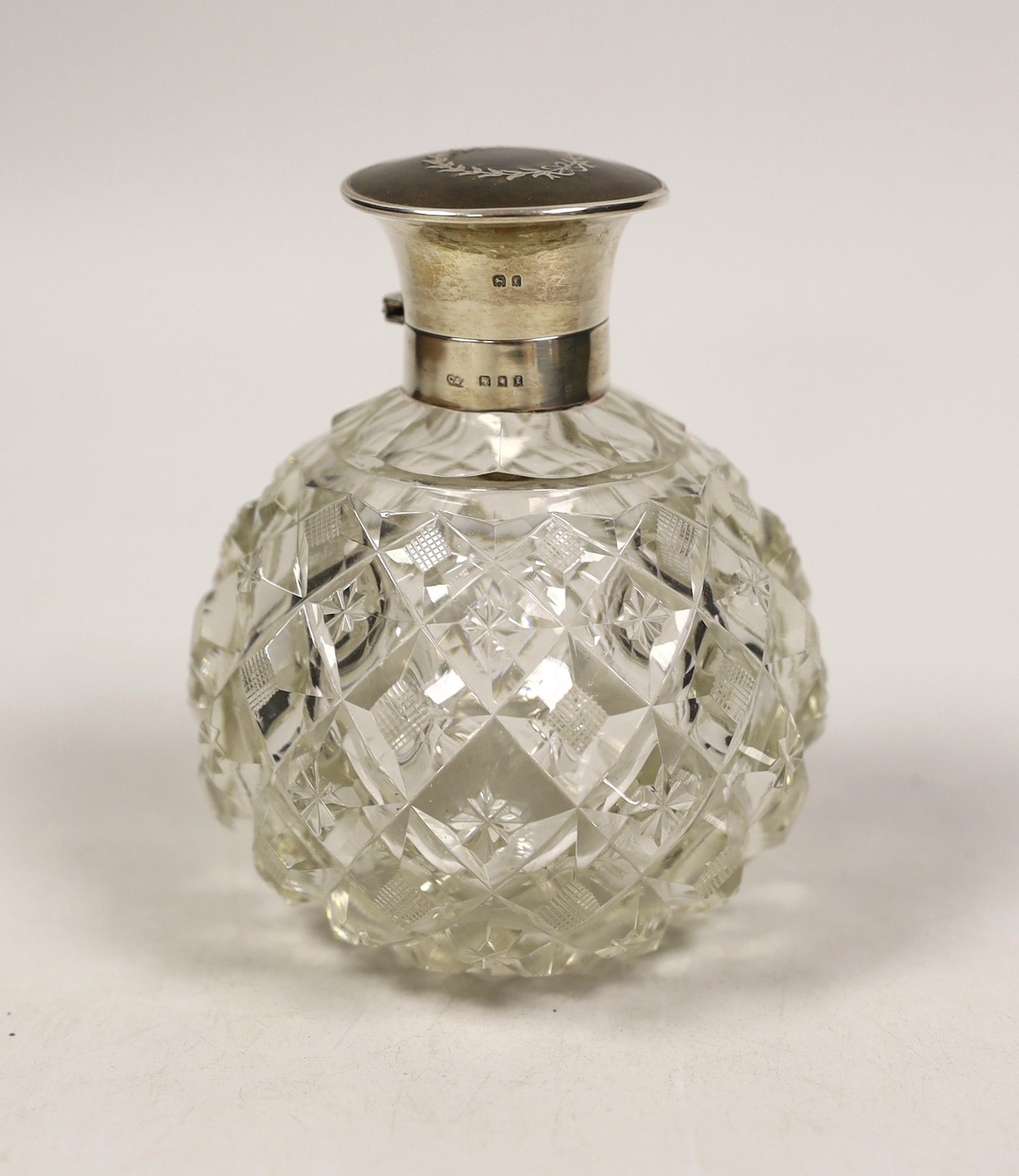 A George V silver and tortoiseshell pique mounted heavy cut glass scent bottle, London, 1921, height 12.5cm.